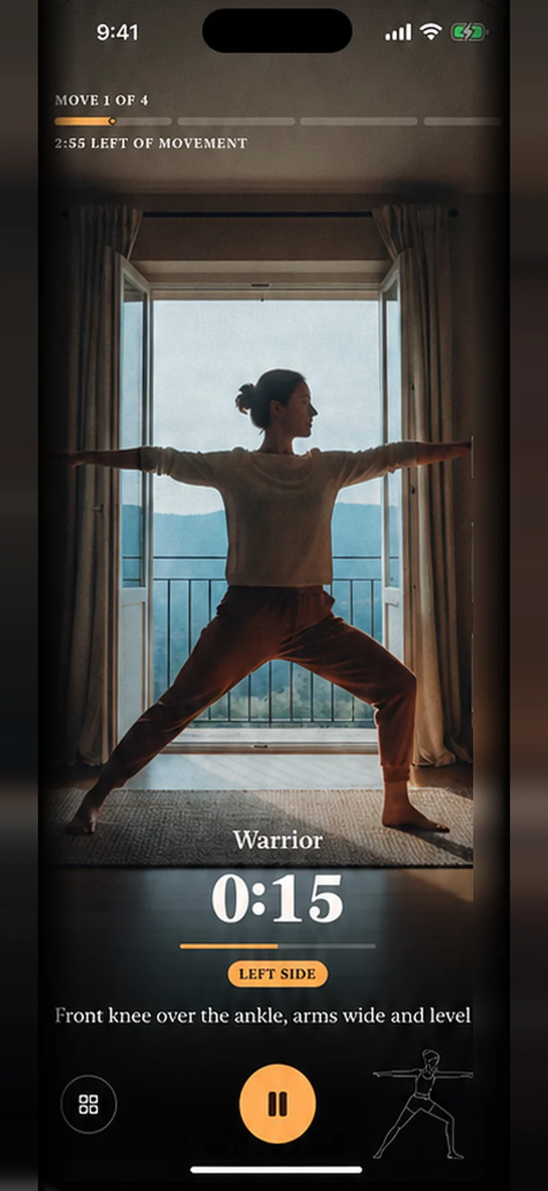 The movement screen on camera: a woman holding Warrior pose at a window, fifteen seconds in, with the cue front knee over the ankle, arms wide and level.